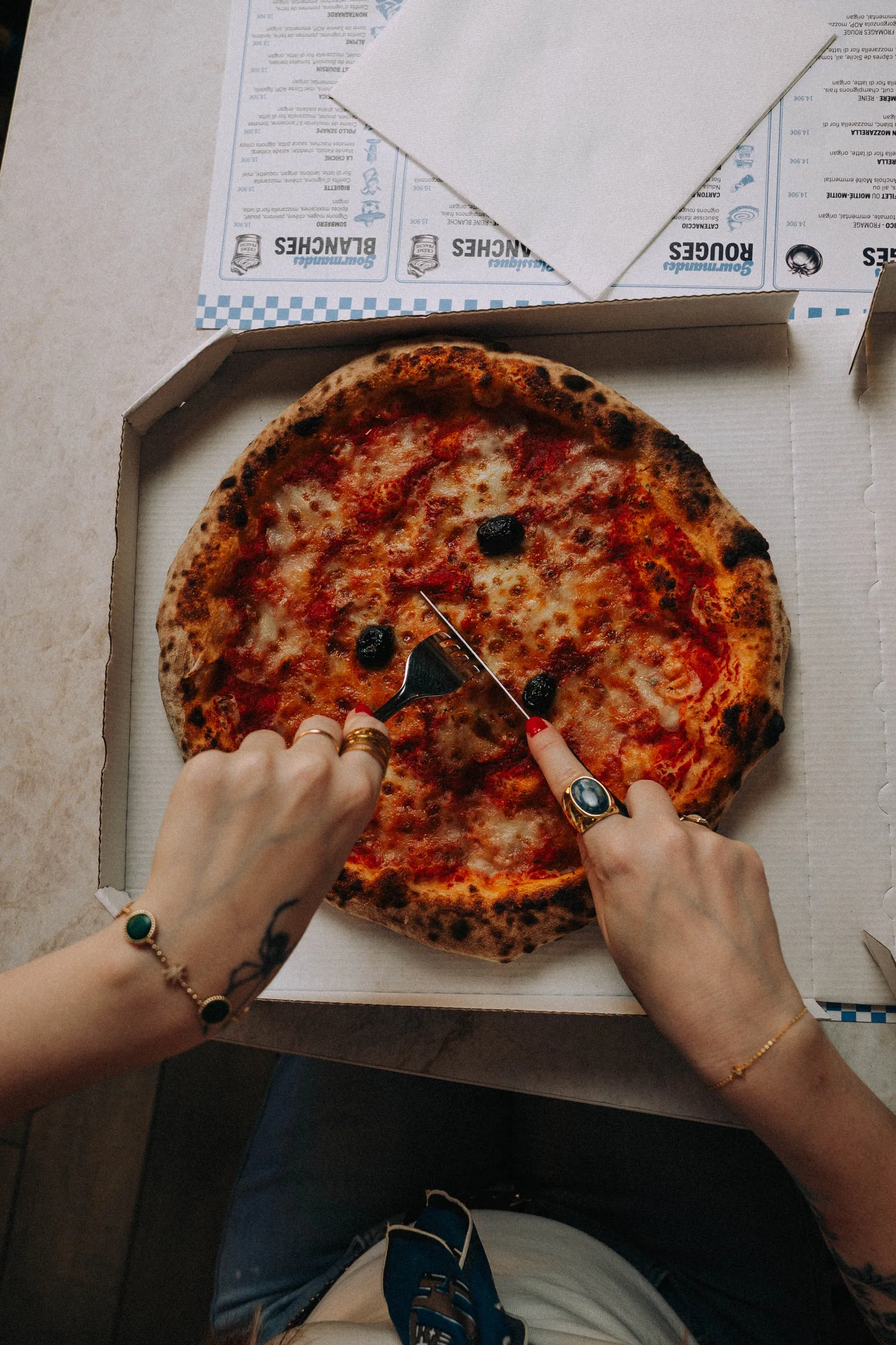Mains partageant une pizza Casa Di Meco
